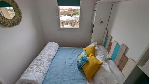 a small room with a bed and a window at appartement T2 biscarosse plage in Biscarrosse-Plage