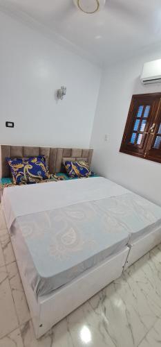 a large white bed in a white room at La Terrace in Aswan