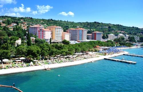 a view of a beach with buildings and the water at Apartment Jadranka in Portorož