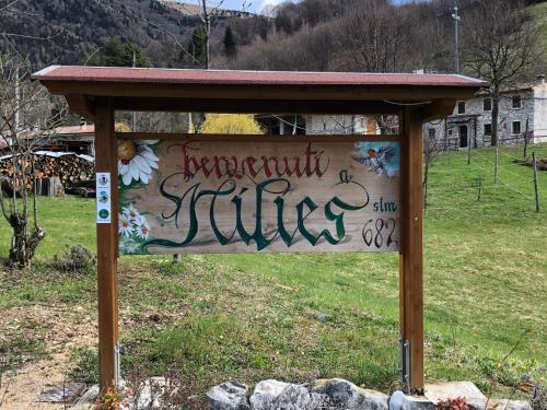 a sign with graffiti on it in a field at CASA ANGELA Stayerat a SEGUSINO Valdobbiadene in Segusino