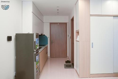 une petite cuisine avec un réfrigérateur et un couloir dans l'établissement Vinhomes Smartcity-Căn hộ dich vụ -Zhomestay, à Thượng Thôn