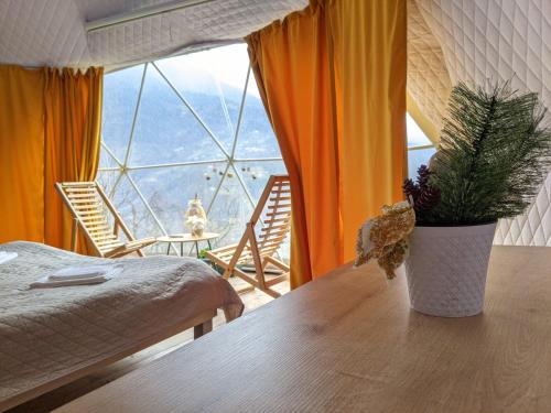 a room with a table with a potted plant on it at Ajara Glamping Kokotauri in Keda