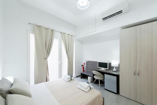 1 dormitorio con 1 cama y escritorio con ordenador en Byron Rooms, en La Spezia