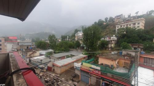 a view of a city with buildings and a river at Hotel Crown City in Muzaffarabad
