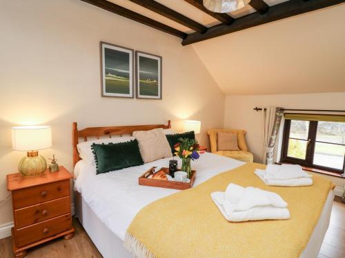 Un dormitorio con una cama y una mesa con toallas. en The Woodman en Llandrindod Wells