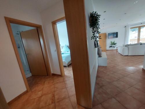 a room with a living room with a couch and a room with at Apartment Traumblick in Unterammergau