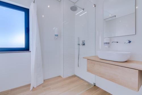 a white bathroom with a sink and a shower at FormosaTavira Seaview @Homesbyfc in Tavira
