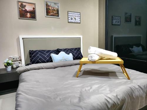 a bed with a yellow tray on top of it at Liberty Arc Studio 舒适和家温暖的感觉 in Ampang