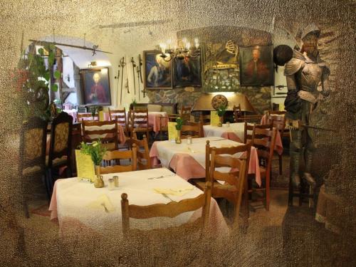 a restaurant with tables and a statue of a man at Burg-Hotel & Hostel Cochem in Cochem