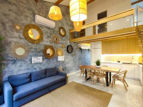 a living room with a blue couch and a table at Ocean House in Ovar
