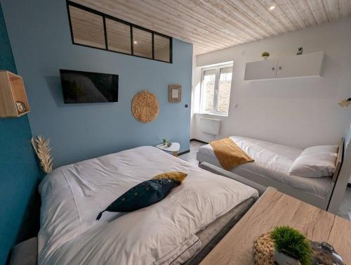 a bedroom with a bed with a fish pillow on it at Le Studio Pop in Paray-le-Monial