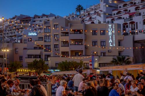 a crowd of people standing in front of a building at Turial Old Town Ocean View in Albufeira