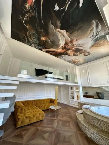 a living room with a couch and a painting on the ceiling at Loft City View in Budapest