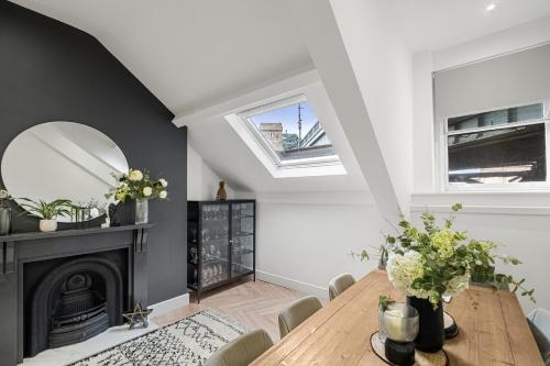 a dining room with a table and a fireplace at Princes Wharf, Stylish 2 Bed City Centre Apartment in Newcastle upon Tyne