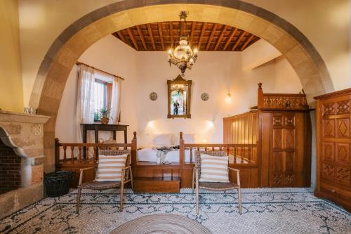 a living room with a fireplace and an archway at ARTE LINDOS VILLA in Líndos