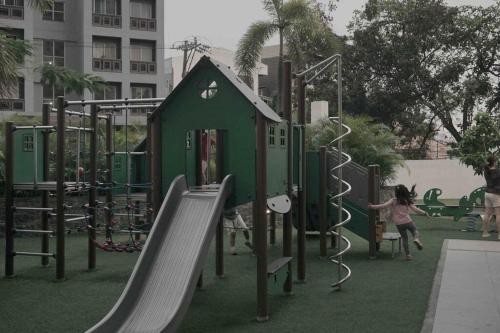 a child playing on a playground in a park at Weston 1 bedroom Unit with Balcony in Manila