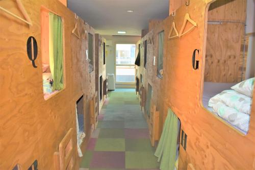 a hallway of a dorm room with bunk beds at HOSTEL PAQ tokushima in Tokushima