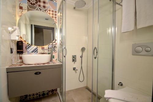 a bathroom with a sink and a shower at Exceptional Flat with Terrace near Hadrian's Gate in Antalya