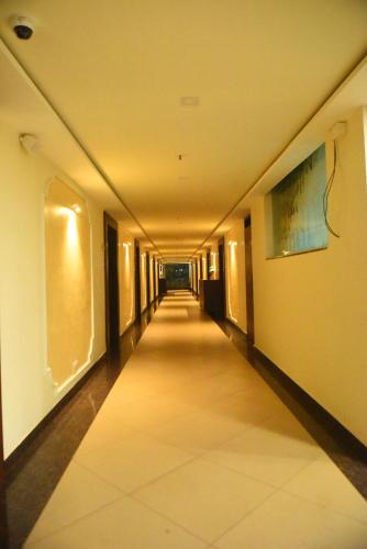 a hallway in a building with a long corridor at M R Residency Dharwad. in Dhārwād
