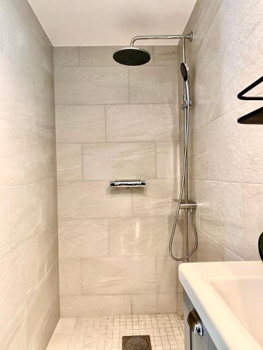 a bathroom with a shower and a sink at Tosthult Holiday 2 in Lönsboda