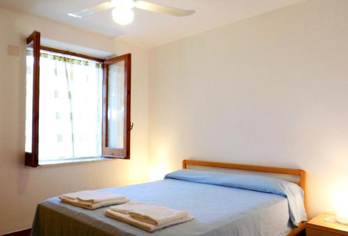 a bedroom with a bed with two towels on it at Le Case di Concetta in Santa Maria