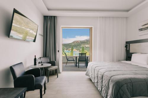 a hotel room with a bed and a table at Lighthouse Apartments in Stoupa