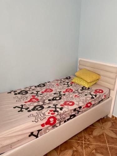 a bed with red flowers on it in a room at Bodrum 3 bedrooms family villa dublex in Bodrum City