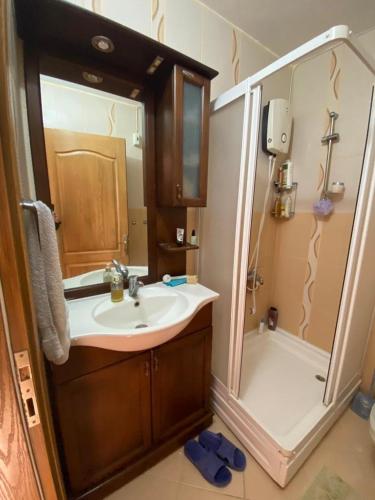 a bathroom with a sink and a shower with a mirror at Bodrum 3 bedrooms family villa dublex in Bodrum City