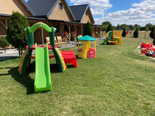 a group of playground equipment in the yard of a house at Ustecka Osada - Ustka (Przewłoka) in Ustka