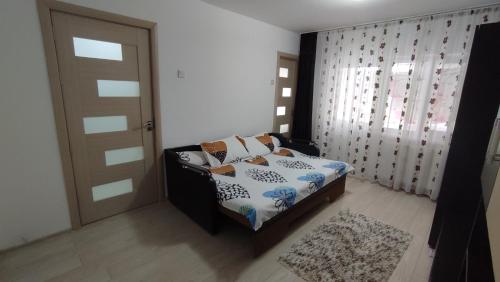 a bedroom with a bed and a door and a rug at Închiriez garsonieră Regim hotelier in Râmnicu Vâlcea