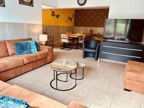 a living room with a couch and a table at Les Bastinettes in Stoumont