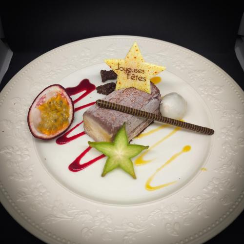 a white plate with a piece of food on it at Le Manoir Au Lac in Gérardmer