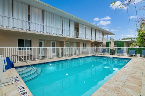 a swimming pool in front of a building at Downtown Starfish 807 in Naples