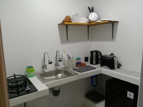 a kitchen counter with a sink and a stove at Villa Giyor in Nusa Lembongan