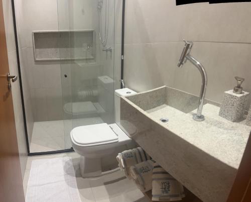 La salle de bains est pourvue de toilettes et d'une douche en verre. dans l'établissement Villas Manatee - Casa Patacho E002, à Porto de Pedras
