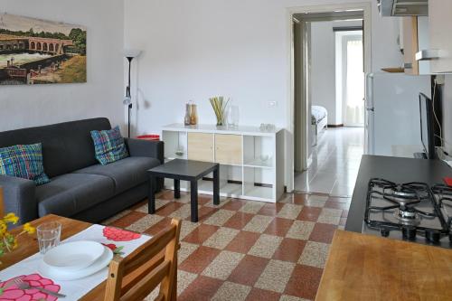 a living room with a couch and a table at Accomodo MIB25 Bivano Navigli in Milan