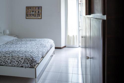 a bedroom with a bed next to a door at Accomodo MIB25 Bivano Navigli in Milan