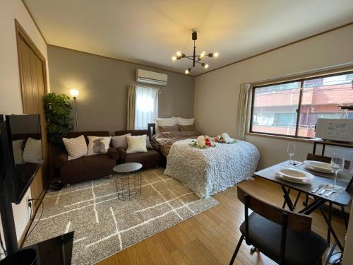 a living room with a couch and a table at Best Shinjuku Modern Full-furnished Apartment1 ONLY 2min to Shinjuku by Train in Tokyo
