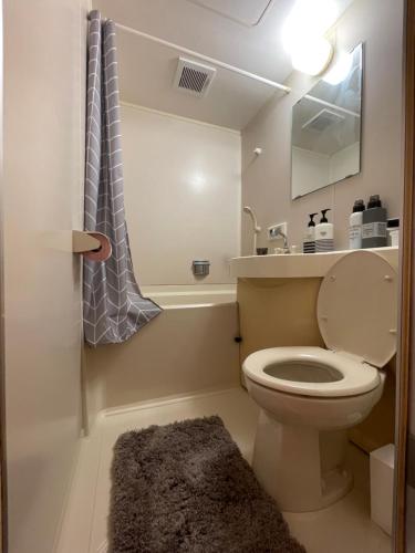 a bathroom with a toilet and a sink and a mirror at Best Shinjuku Modern Full-furnished Apartment1 ONLY 2min to Shinjuku by Train in Tokyo
