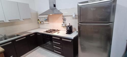 a kitchen with a stainless steel refrigerator and a sink at Sole & Luna in Olmedo