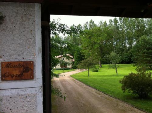 a view from a door of a house with a driveway at MOULIN CROZET in Montceaux