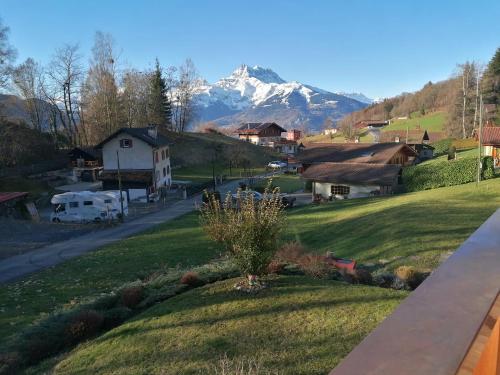 a view from the balcony of a house with a mountain at Les Comblés des Combes in Ollon