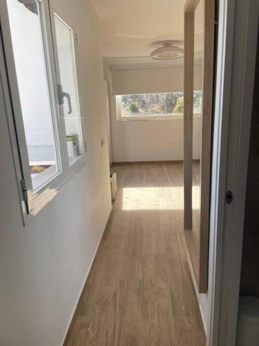 an empty room with a hallway with a window at The Nook at Monda in Monda