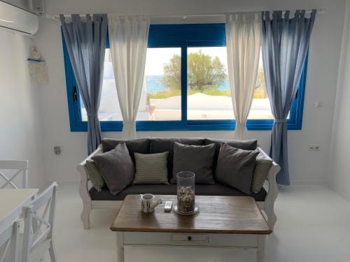 a living room with a couch and a table at Blue Sea Villa & Apartments in Makry Gialos