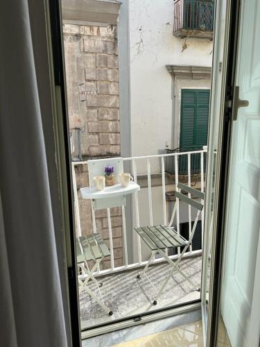 a view of a balcony with a table and chairs at Leone Suites Toledo in Naples
