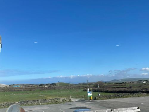 a parking lot with mountains in the background at Mayfair, Tintagel 3 bed sleeps 6 in Tintagel