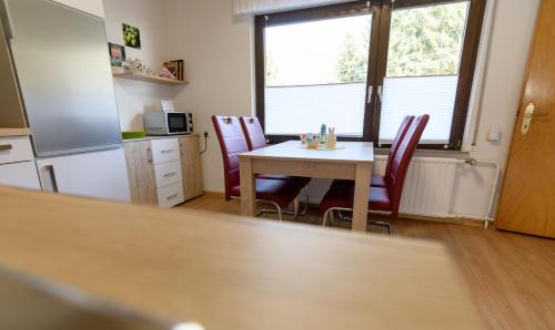 a kitchen and dining room with a table and chairs at Haus Kallin in Idar-Oberstein