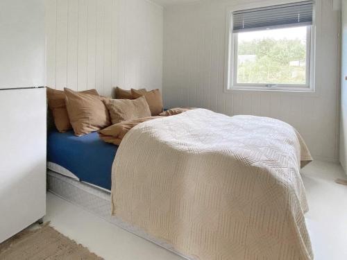 a bed sitting in a room with a window at Holiday home Åsenfjord 