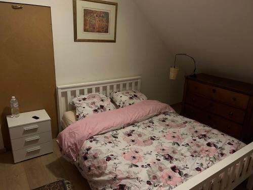 a bedroom with a bed and a dresser at Haylenes in Tourcoing