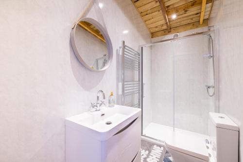 a white bathroom with a sink and a shower at Den of Joy Humberston Fitties sleeps 6,hot tub,log burner in Cleethorpes